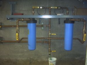 A two stage filtration system installed inline in a home's water supply line