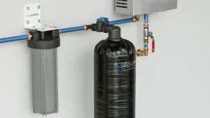 An inline pre filter and water conditioner installed in a home's water supply line before the water heater