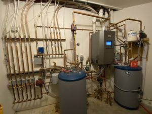 A photo of a retrofit boiler system with a modulating condensing high efficiency boiler.