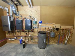 A photo of a 1 gas and 2 electric boiler system fed by a solar array.