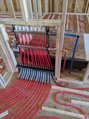 A new construction radiant heating system being installed in a home's subfloot